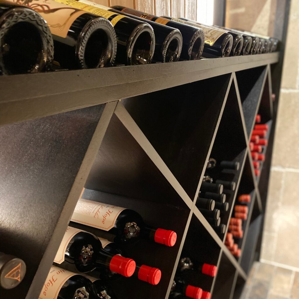 Close up of wine bottles in wine cellar.