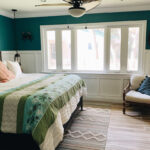 Beach bedroom with wainscoting and window trim
