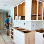Greg Byrus installing kitchen cabinets