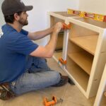 Greg Byrus installing office cabinets